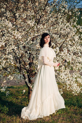 Fototapeta premium girl next to a flowering tree