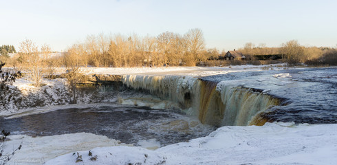 Frozen Jagala waterfall, ice curtain and  sculptures. 8 m high and over 50 m wide fall. Winter landscape. Ice curtains from frost. Popular walking area. Lower course of Jägala River . Estonia