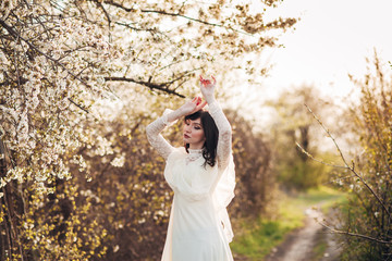 
girl next to a flowering tree