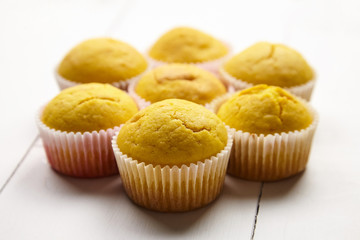 Muffins on white table. Group of cupcakes on wooden background. Homemade bakery