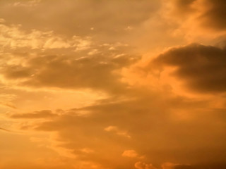 Naklejka na ściany i meble Clouds on sunset sky, warm color, orange sky background