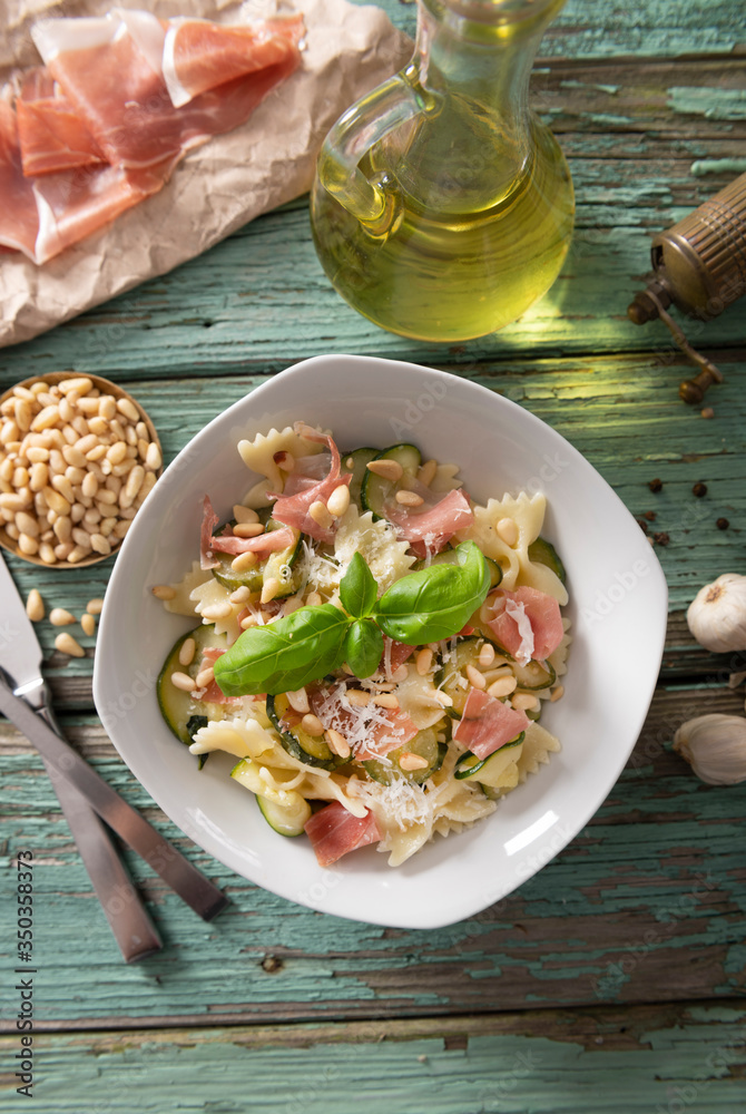 Wall mural Farfalle pasta with courgette, pine nuts and prosciutto ham - Wall murals
