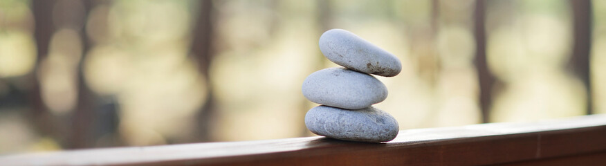 Background with three white stones at sunset, concept relaxation, wellness and mindfulness.