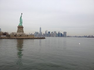 Obraz premium A skyline photo of the Statue of Liberty Island, New York .A nice view of Manhattan in the far back