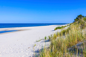 Beautiful sandy beach on Hel Peninsula, Baltic sea, Pomeranian Voivodeship, Poland. Hel is a 35-km-long sand bar peninsula in northern Poland separating the Bay of Puck from the open Baltic Sea - obrazy, fototapety, plakaty