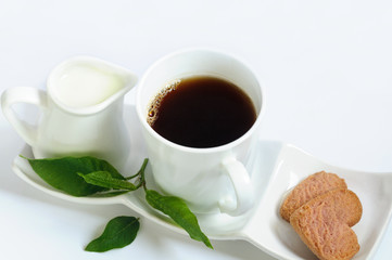 Organic coffee in a white mug with milk and raspberry cookies.