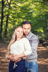 Fototapeta premium Portrait of young couple enjoying a day in the park together
