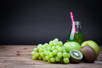 Obraz premium Vegetarian healthy food. Source of protein for vegetarians. Healthy eating: kiwi, grapes, apple, juice on dark background.