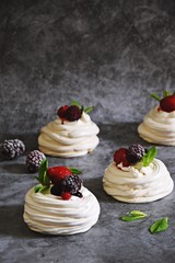 Berry Pavlova Cake dessert on the grey background