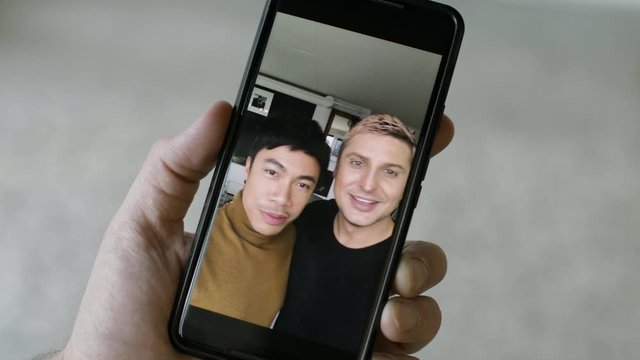 Happy gay couple does video chat with family and friends. Shot on RED camera in 4k. 