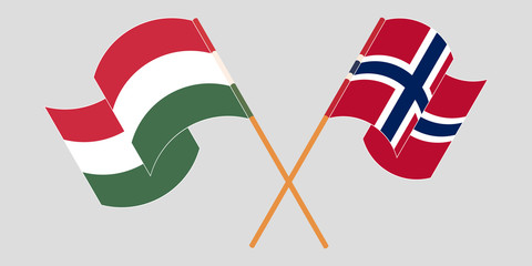 Crossed and waving flags of Hungary and Norway