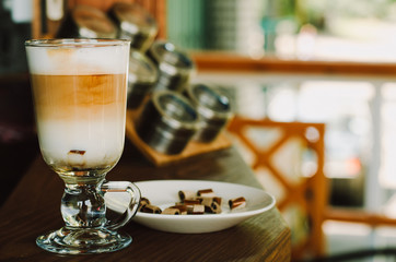 Hot latte coffee in glasse cup on a wooden table.. Morning homemade coffee. Relaxing time concept. Copy space. Selective focus.