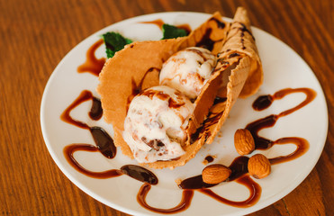 Waffle with almond, ice cream and mint. Snack, strawberry. Selective Focus