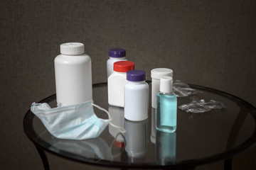 Medicine chest . A used coronavirus mask, vials of medication, and disinfectant are on the bedside table.