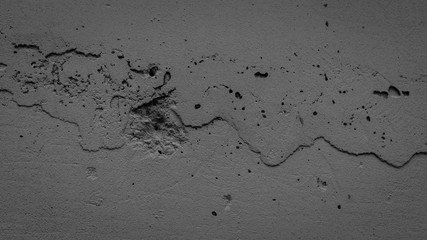 Textured concrete wall background. Rough texture. Cracks in the wall.