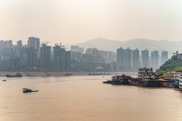 Fengdu, Chongqing, China - May 8, 2010: Yangtze River. Cityscape of high buildings on shoreline...