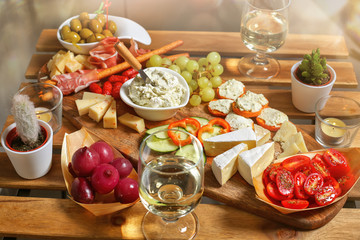 Italian drink aperitif.Traditional Italian snacks (antipasto): salami, ham, cheese, onion pickles,...