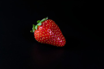 Fresh and juicy  red strawberry on black background