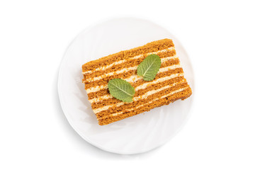 Homemade honey cake with milk cream and mint isolated on white background. Top view.