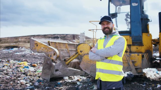 Front view of worker on landfill, waste management and environmental concept.