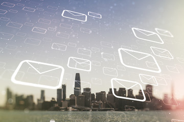 Double exposure of abstract virtual postal envelopes hologram on San Francisco city skyscrapers...