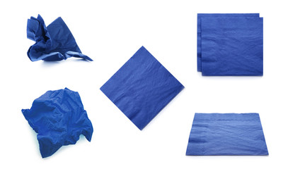 Set with blue paper napkins on white background