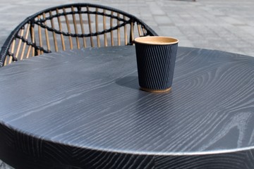 americano in eco-friendly cup on the open air cafe table