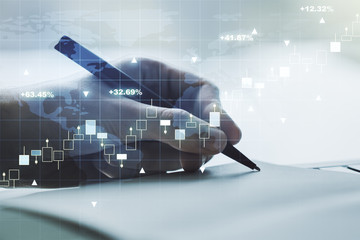 Abstract creative financial graph with world map and with man hand writing in notebook on background, forex and investment concept. Multiexposure