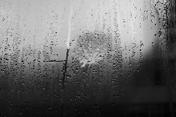 Fog and raindrops on window glass texture background