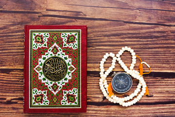 Quran is your guidance of your life concept with the Koran, prayer beads and compass. Large writen Arabic word mentioned Holy Quran is with variance recitation and correct pronounciations method.