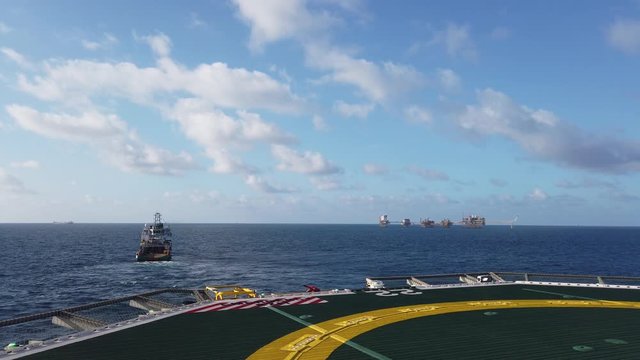 Offshore Supply Vessel and Central processing platform (cpp) in the middle of the ocean on sunny day - upstream industry
