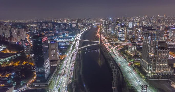 Aerial hyperlapse of Sao Paulo city at night with cars, trains and helicopters. Heavy traffic, buildings and city lights. Brazil
