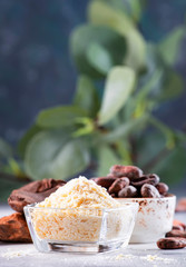 Organic cocoa butter, cocoa beans, grated cocoa lump, dark chocolate on gray blue background. Copy space