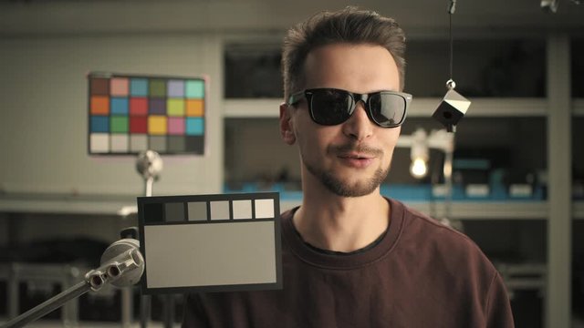 Graded and balanced by ColorChecker. Man testing professional film camera. ColorChecker Gray Scale, Classic Card and spidercube. It helps to ensure eccurate color balance. RED MONSTRO, Lens 32 mm