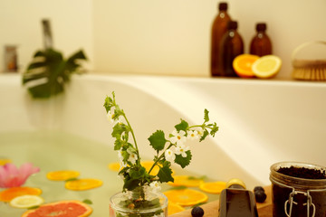 Relaxing bath with fresh fruits and flowers.