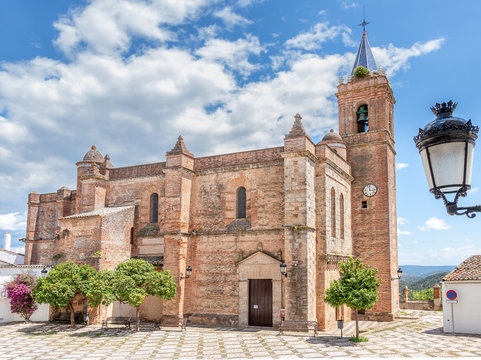 View of Church of the Immaculate Conception (Iglesia de la Inmaculada Concepcion) in the village of Zufre with a beautiful old style hanging lamp in the foreground, Huelva mountains, Spain.