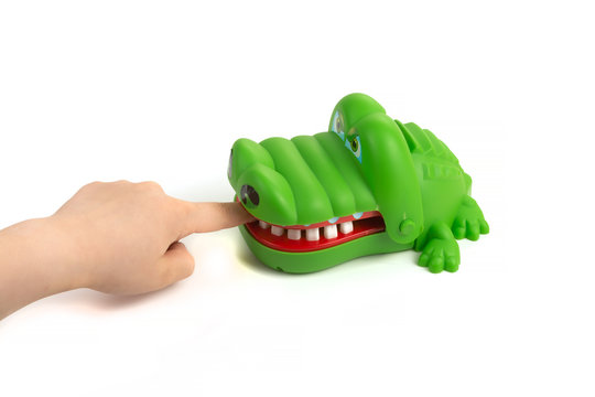 Child shoved finger into mouth of toy crocodile