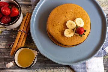 hot cakes or pancakes with red berries, strawberries, blackberries for breakfast, top view, horizontal