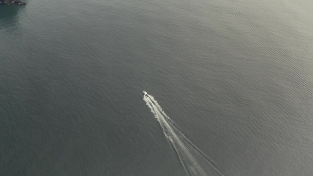Fast motorboat on the see aerial view, dronw follow shot