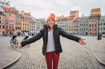 Young woman in the old town of warsaw, poland - obrazy, fototapety, plakaty