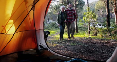 Close up senior couple with dog getting inside tent