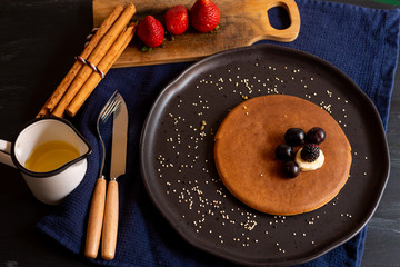 hot cakes or pancakes with red berries, strawberries, blackberries for breakfast, top view, horizontal