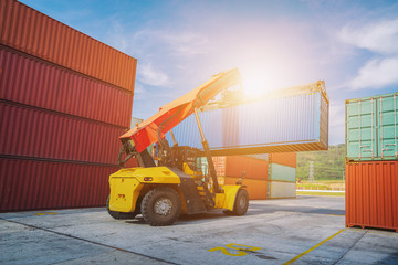 Forklift truck working lifting cargo industrial container box at shipping yard for transportation import,export and logistic industrial