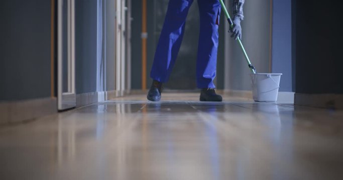 Janitor cleaning a corridor
