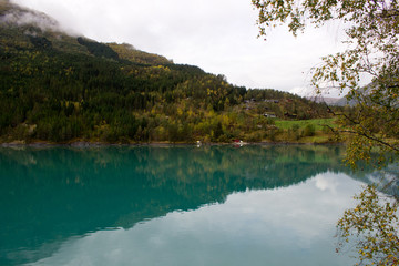 Beautiful norwegian landscape in autumn near Loen and Stryn in Norway.Lake with turquoise water surruonded by mountains.Lovatnet in autumn,photo for printing on calendar,poster,wallpaper,postcard