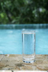 A glass of water by the poolside