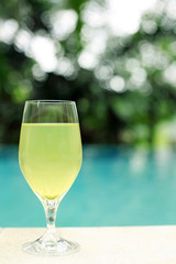 A glass of cold drink by the poolside