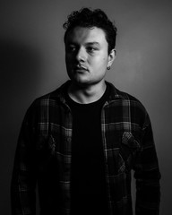 Young handsome man posing and playing guitar