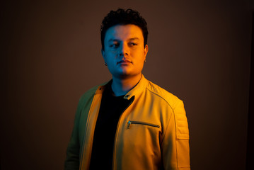 Young handsome man posing and playing guitar