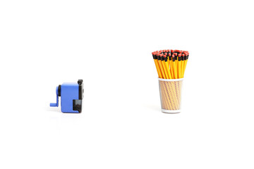 A sharpener and a pencil holder full with pencils